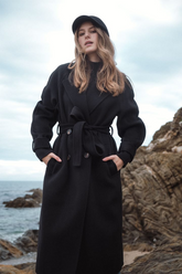 a lady in a long black wool coat